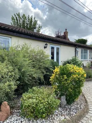 a house with some bushes in front of it at One Bedroom Bungalow No1 - Secure Gated Parking in Basildon