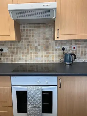 a kitchen with a white stove top oven at One Bedroom Bungalow No1 - Secure Gated Parking in Basildon