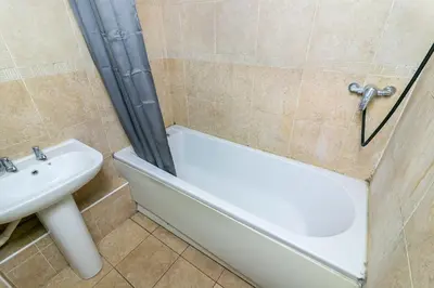 a bathroom with a sink and a tub and a toilet at Parkview Guesthouse in Graveley