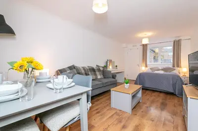 a living room with a couch and a table at Parkview Guesthouse in Graveley