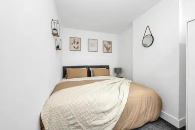 a bedroom with a bed in a white room at Wherstead Rd House By Homestyles Hosts Short Lets & Serviced Accommodation Suffolk With Free Parking in Ipswich