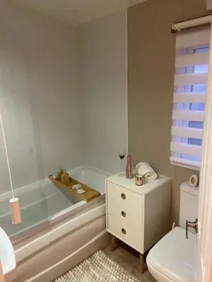 a bathroom with a tub and a toilet and a sink at Lakeside mini lodge in Saint Osyth