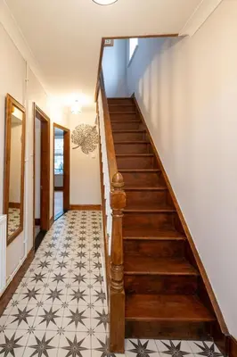 a staircase in a house with a tile floor at 10 Jubilee Cottage in Leiston