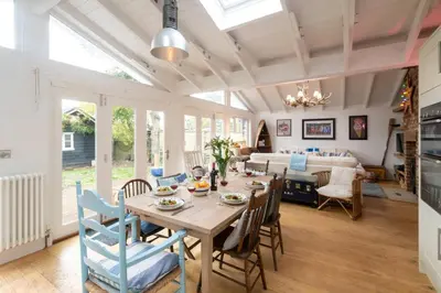 a dining room with a table and chairs at 3 Uplands, Thorpeness - Sleeps 3, Close to Beach, Boating Lake, Thorpeness Golf Club and Country Club - Aldeburgh Coastal Cottages in Thorpeness