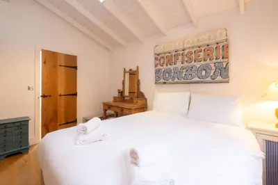 a bedroom with a white bed in a room at 3 Uplands, Thorpeness - Sleeps 3, Close to Beach, Boating Lake, Thorpeness Golf Club and Country Club - Aldeburgh Coastal Cottages in Thorpeness