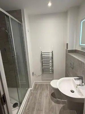 a bathroom with a shower and a toilet and a sink at Station stay in Harlow