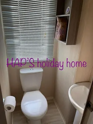 a bathroom with a white toilet and a sink at HAPs Holiday Home - Haven The Orchards in Brightlingsea