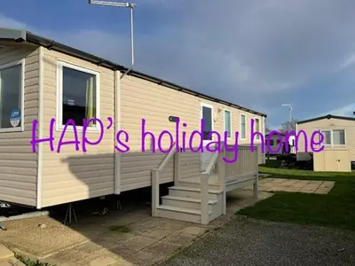 a house with a sign that reads happy holiday eve at HAPs Holiday Home - Haven The Orchards in Brightlingsea