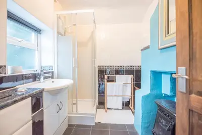 a bathroom with a sink and a shower at 2 Lion Cottages, Knodishall in Leiston