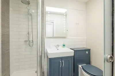 a bathroom with a toilet and a sink and a shower at Beautiful 2bed Central Home in Cambridge