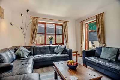 a living room with two leather couches and a table at 4 Bed in Woodbridge oc-s27356 in Martlesham