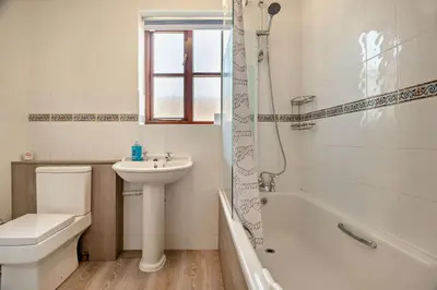 a bathroom with a sink and a toilet and a shower at 4 Bed in Woodbridge oc-s27356 in Martlesham