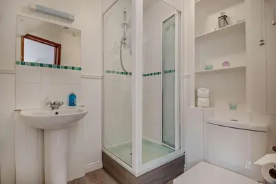 a white bathroom with a shower and a sink at 4 Bed in Woodbridge oc-s27356 in Martlesham