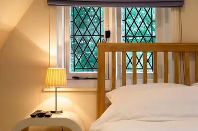 a bedroom with a bed and a window at Hill House Norfolk in Saxlingham Nethergate