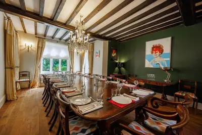a large dining room with a long table with chairs at Hill House Norfolk in Saxlingham Nethergate
