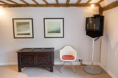 a room with a desk and a tv and a chair at Hill House Norfolk in Saxlingham Nethergate