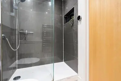 a shower with a glass door in a bathroom at Luxurious City Centre Cosy WiFi and Netflix in Chesterton