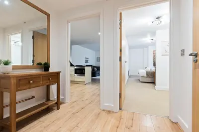 a living room with a mirror and a wooden table at Luxurious City Centre Cosy WiFi and Netflix in Chesterton