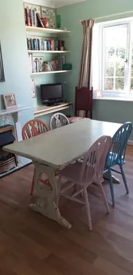 a table and chairs in a living room at Crow Corner in Yoxford