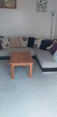 a living room with a couch and a coffee table at Crow Corner in Yoxford