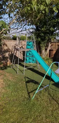 a blue and white slide in the grass at Crow Corner in Yoxford