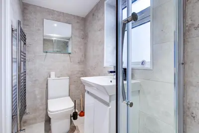 a small bathroom with a toilet and a sink at Sleek 3 Bedroom Home Sleeps 6 with Parking in Colchester