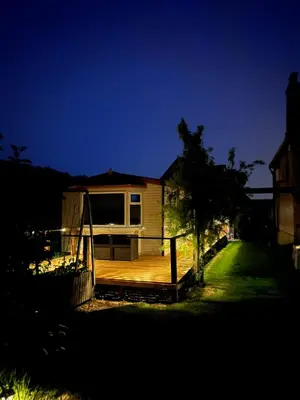 a small house with a deck in the yard at The static, it is what it is! in Wicken