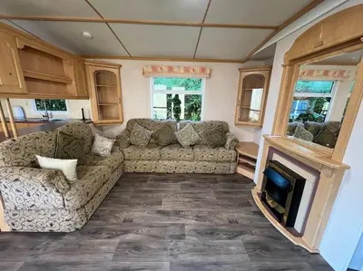 a living room with a couch and a fireplace at The static, it is what it is! in Wicken