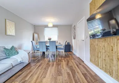 a living room with a table and a couch at Well-Located 4 Bed Property in Colchester, Suited for Families and Business Travelers in Colchester