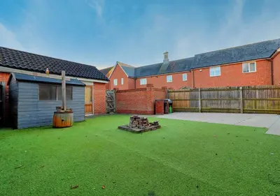 a backyard with a fire pit and a fence at Well-Located 4 Bed Property in Colchester, Suited for Families and Business Travelers in Colchester