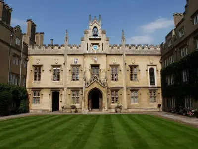 a large building with a clock tower on top of it at Sidney Sussex College, Cambridge in Cambridge