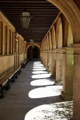 an empty hallway with benches in a building at Sidney Sussex College, Cambridge in Cambridge
