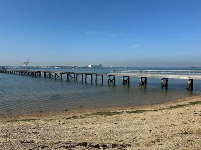 a pier in the water next to a beach at Inishnee House in Ipswich
