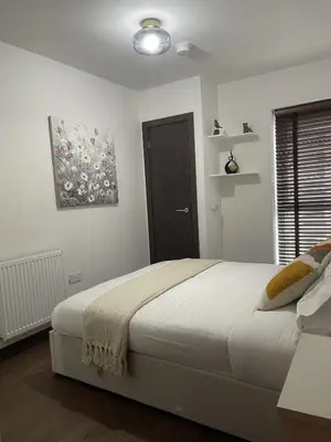 a bedroom with a bed and a painting on the wall at The Comfort, with Free Parking, Harlow in Harlow