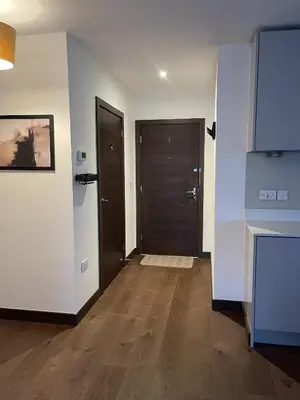 an empty room with two doors and wooden floors at The Comfort, with Free Parking, Harlow in Harlow