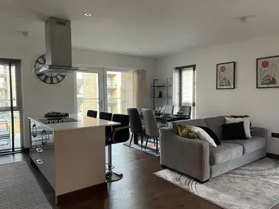 a kitchen and living room with a couch and a table at The Comfort, with Free Parking, Harlow in Harlow