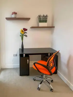 an office with a desk with a chair and flowers at Central Luxury Peaceful Home With Driveway Parking - Cambridge Homehost in Cambridge