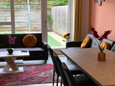 a living room with a table and a couch at Central Luxury Peaceful Home With Driveway Parking - Cambridge Homehost in Cambridge