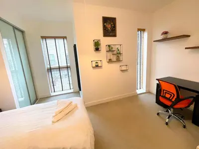 a bedroom with a bed and a desk and a chair at Central Luxury Peaceful Home With Driveway Parking - Cambridge Homehost in Cambridge