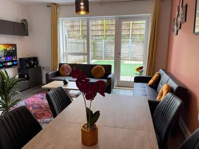 a living room with a table and a couch at Central Luxury Peaceful Home With Driveway Parking - Cambridge Homehost in Cambridge