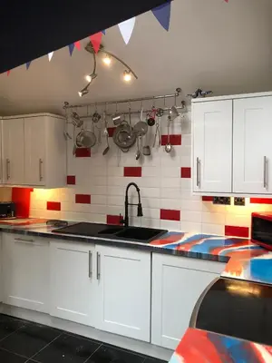 a kitchen with white cabinets and a sink at Susies Place in Thaxted