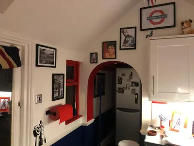 a hallway with an archway and a refrigerator in a room at Susies Place in Thaxted