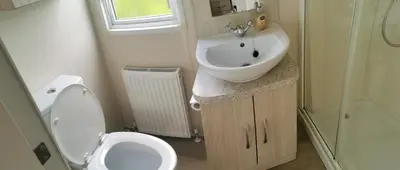 a small bathroom with a sink and a toilet at 3 Bedroom Mersea Beach Retreat-Getaway by the Sea in West Mersea