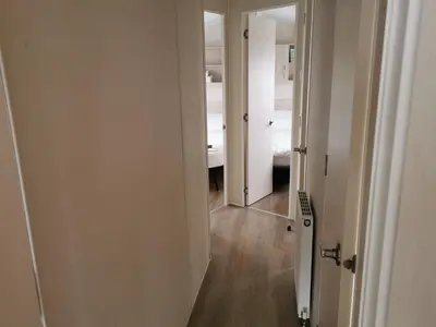 a hallway with an open door to a bedroom at 3 Bedroom Mersea Beach Retreat-Getaway by the Sea in West Mersea