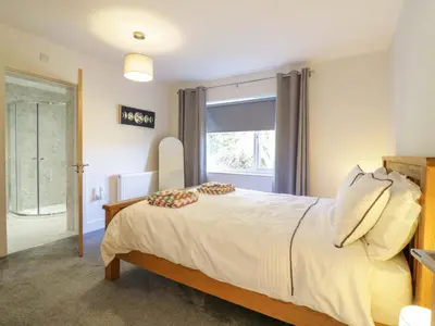 a bedroom with a large bed and a window at Farmer's Rest in Ely