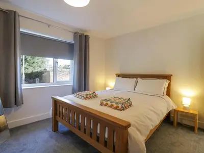 a bedroom with a large bed with two pillows on it at Farmer's Rest in Ely