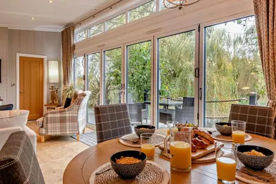 a dining room with a table with food and orange juice at 2 Bed in Welney oc-k30123 in Welney