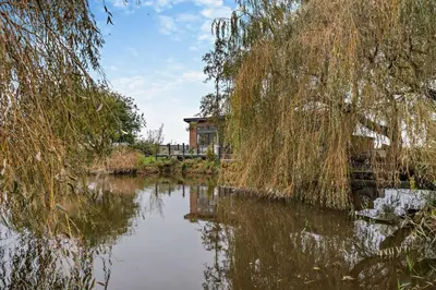 a view of a river with a house in the background at 2 Bed in Welney oc-k30123 in Welney