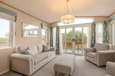 a living room with a couch and chairs and windows at 2 Bed in Welney oc-c30124 in Welney