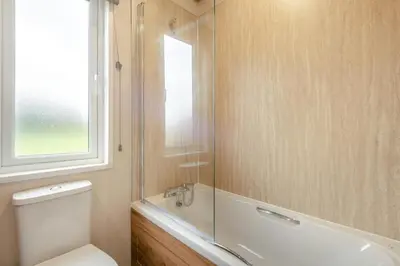 a bathroom with a shower and a toilet and a window at 2 Bed in Welney oc-c30124 in Welney